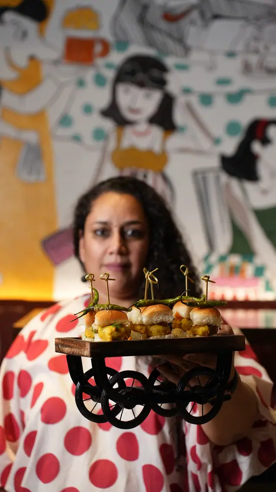 Chef Chiquita Gulati holding a cart of sliders