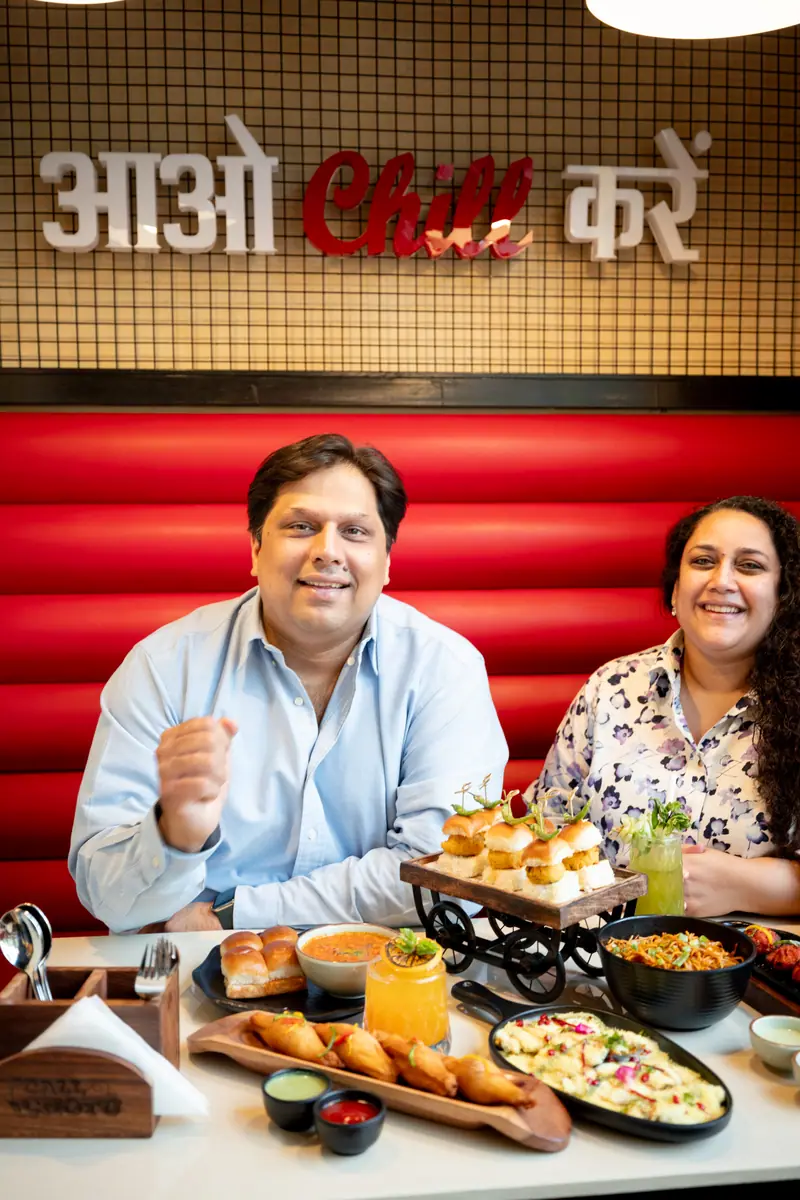 Sumit and Chiquita Gulati in a red Call Chotu booth under an Aao Chill Karein sign