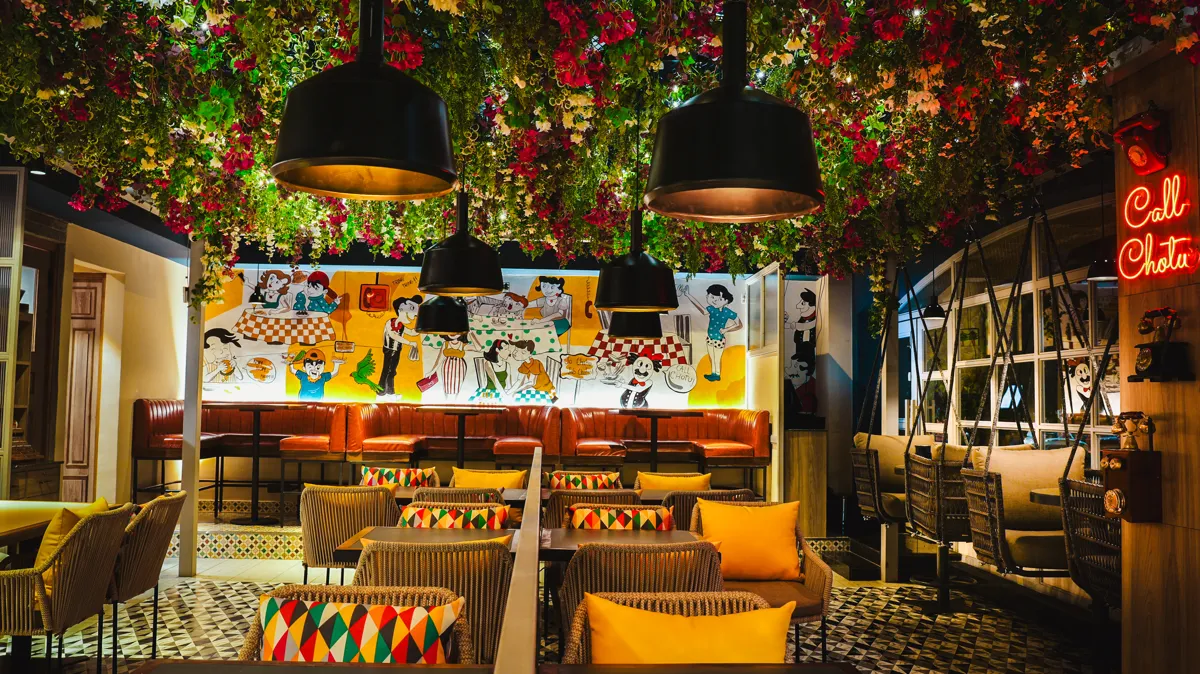 Call Chotu diner with hand-painted murals and flowers overhead